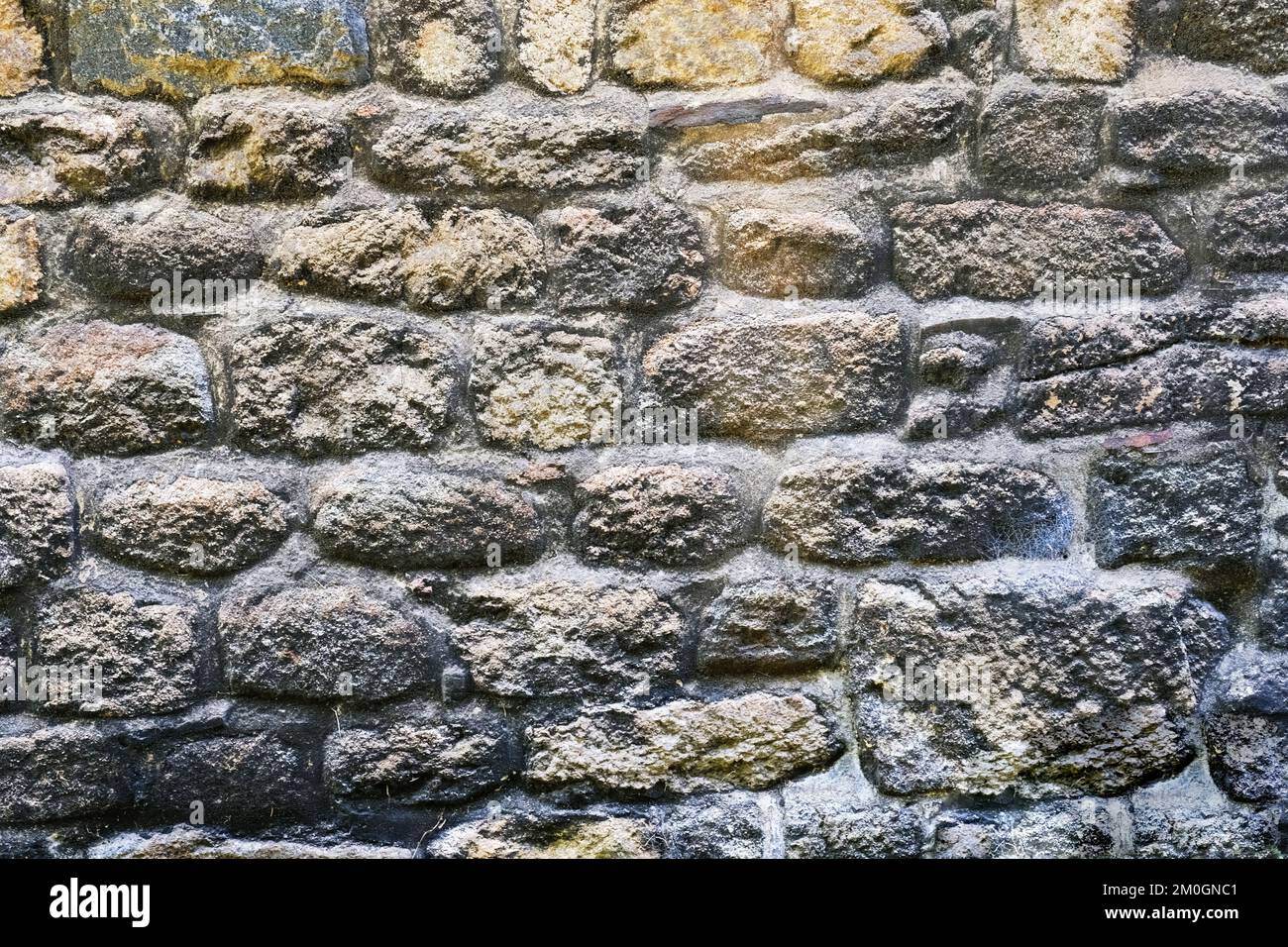 Full frame image of a stone wall, ideal for backgrounds - John Gollop Stock Photo