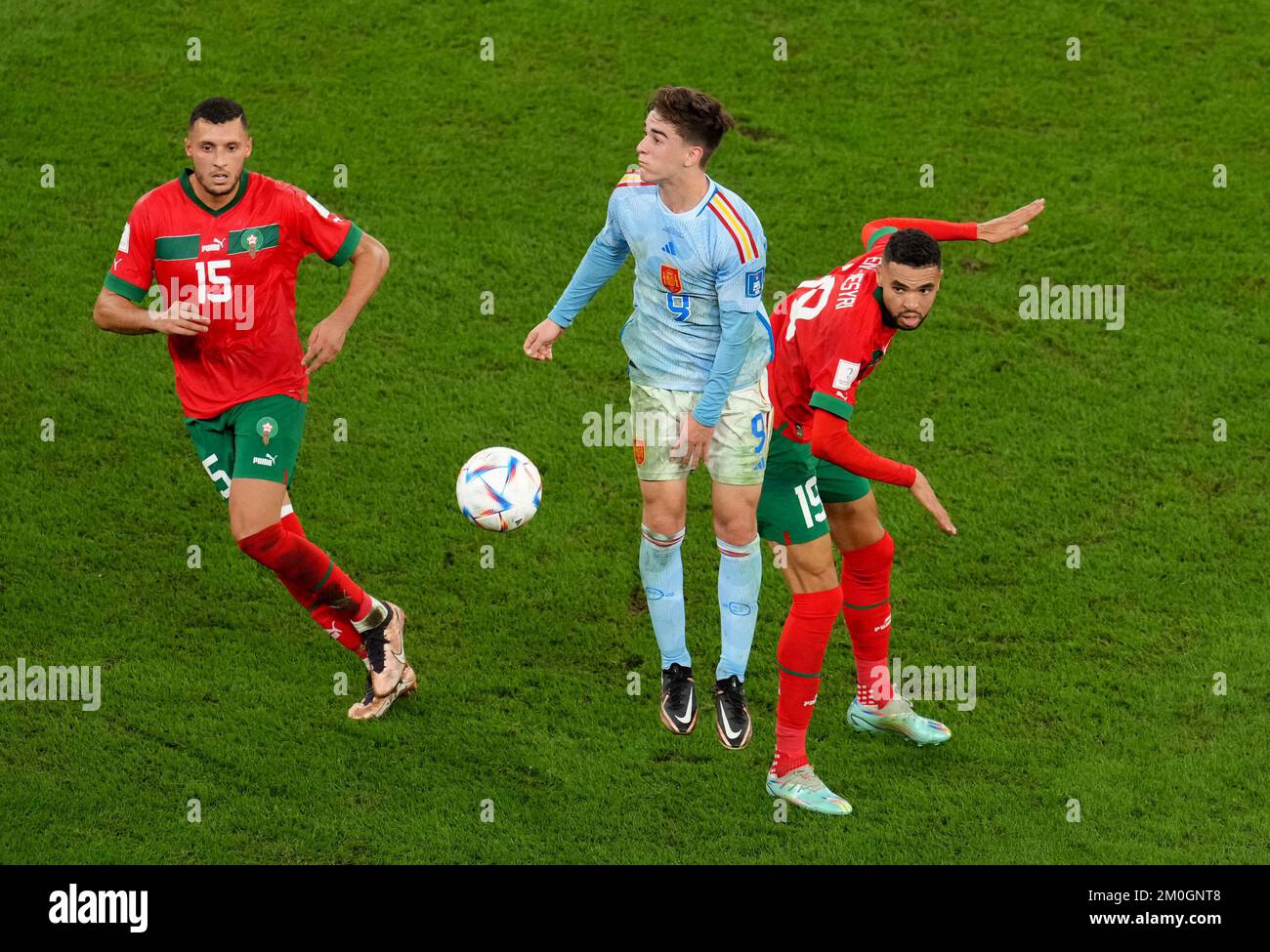 Spain's Gavi (centre) in action with Morocco's Youssef En-Nesyri (right) and Selim Amallah during the FIFA World Cup Round of Sixteen match at the Education City Stadium in Al-Rayyan, Qatar. Picture date: Tuesday December 6, 2022. Stock Photo