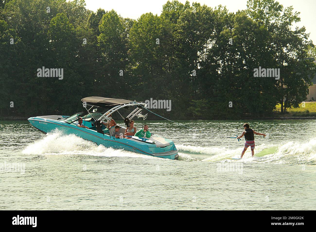 Young boy water skiing with family on a lake in Virginia, USA Stock Photo