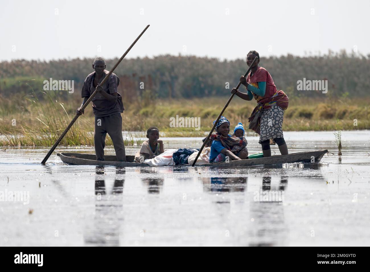 Local family in canoe, dugout canoe, banana boat, Bangweulu swamps, Zambia, Africa Stock Photo