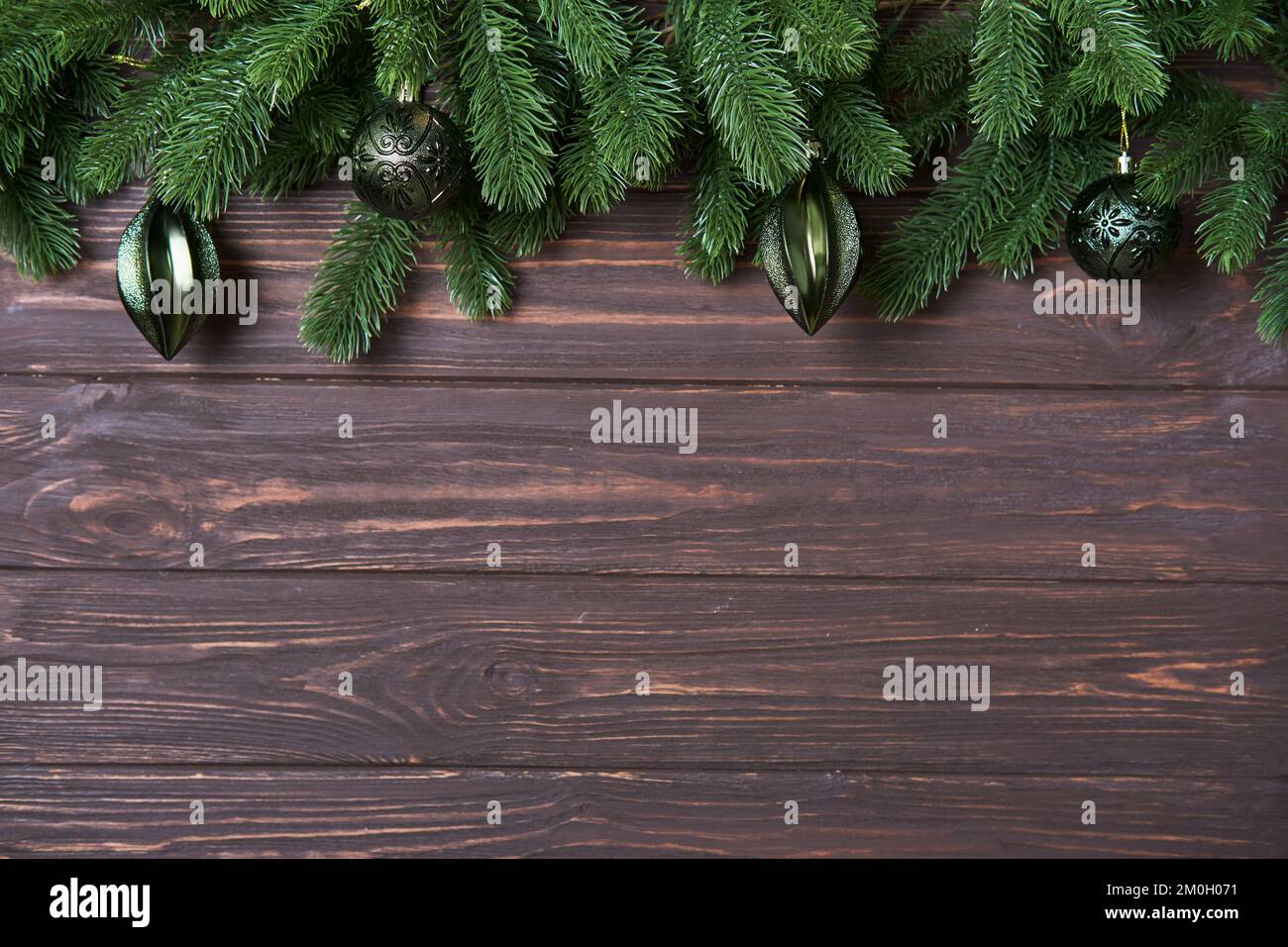 Christmas of New Year background with fir branches and green baubles on ...