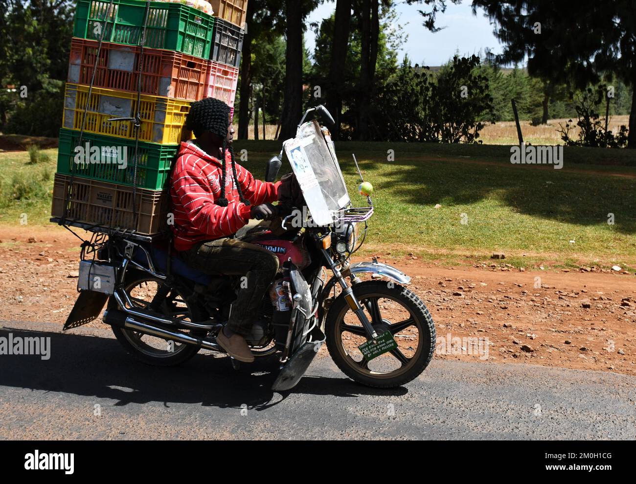 Man rides boxes on a motorbike in Kenya Stock Photo Alamy