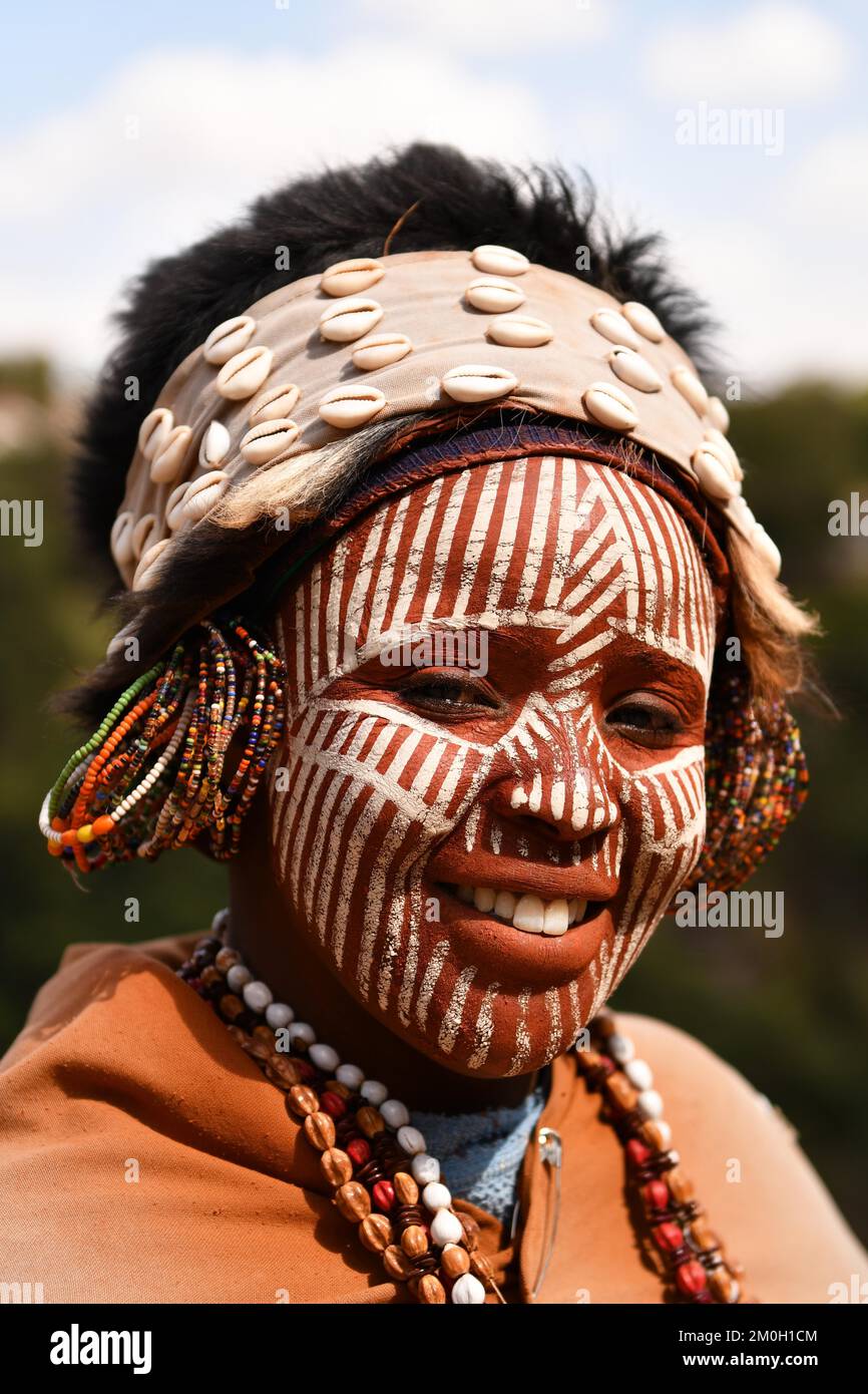 Kikuyu woman with face paint poses for photographers at Nyahururu Falls