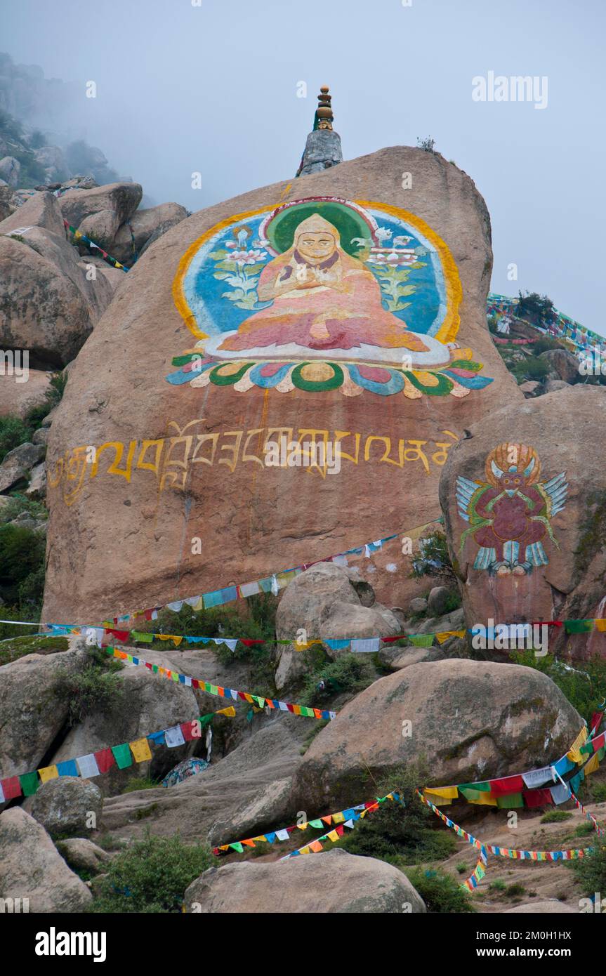 Huge Buddha painted on a rock behind the Drepung temple, Lhasa, Tibet, Asia Stock Photo