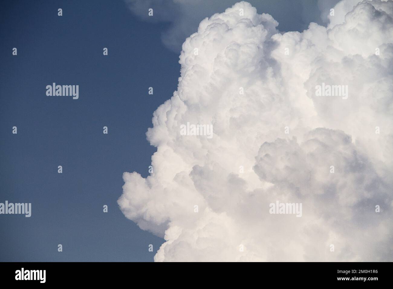 Large cumulonimbus cloud against blue sky in the summertime Stock Photo