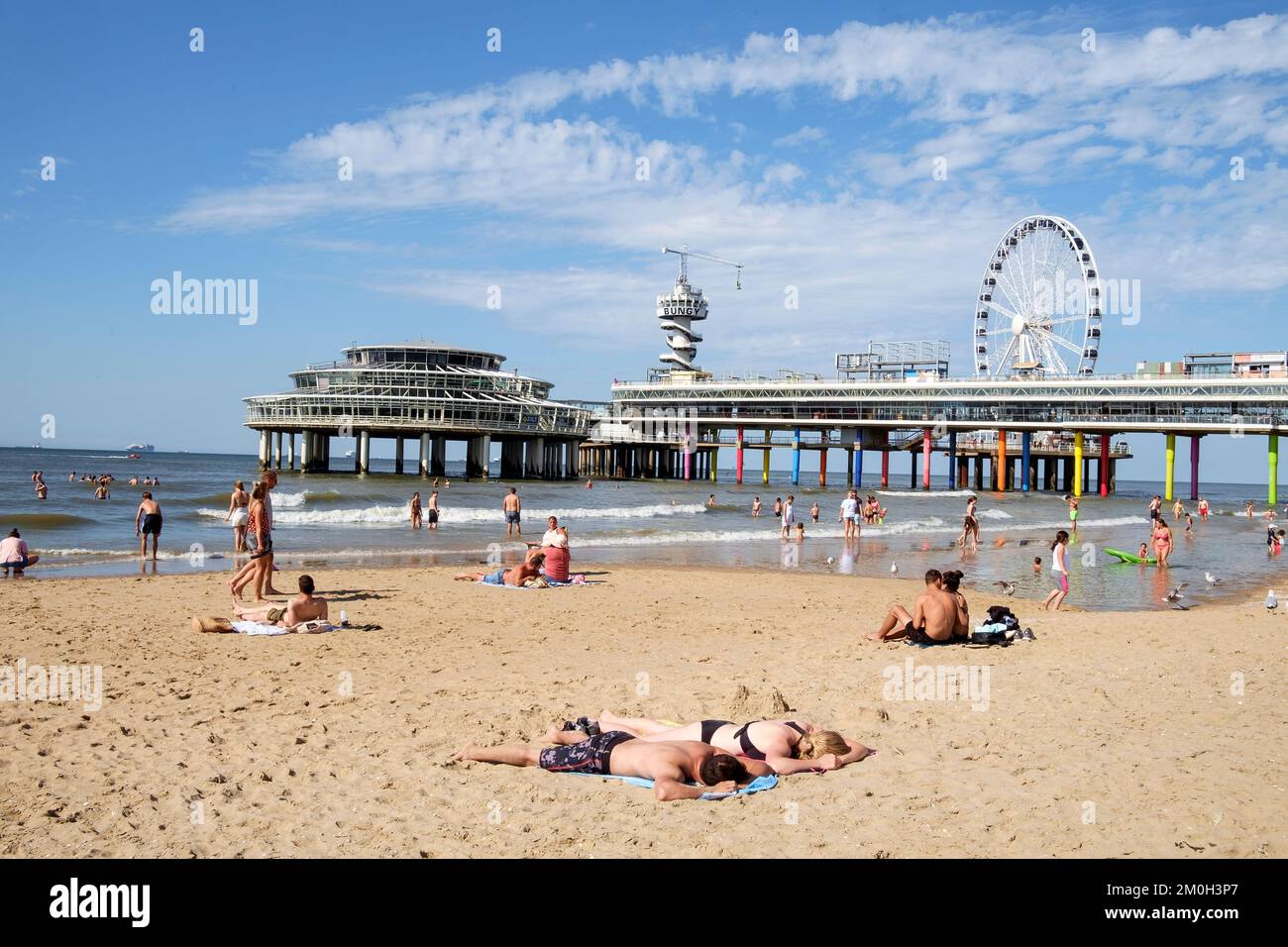 Scheveningen, The Hague, The Nederlands, view of the beach during a Sunday in the summer season with the Pier Stock Photo