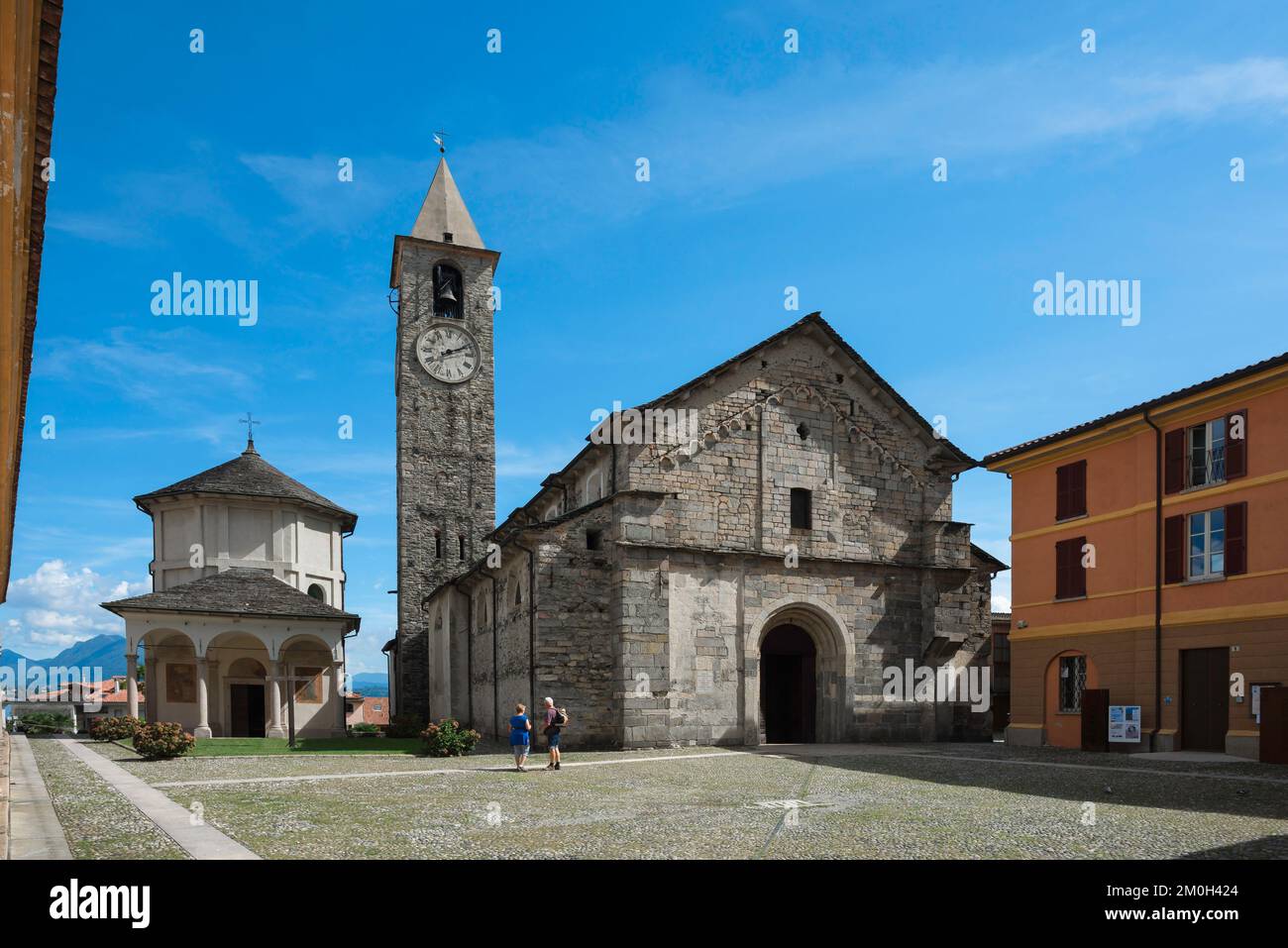 Baveno Italy town, view in summer of the scenic 12th century church and octagonal baptistry in the Piazza della Chiesa in Baveno, Piedmont, Italy Stock Photo