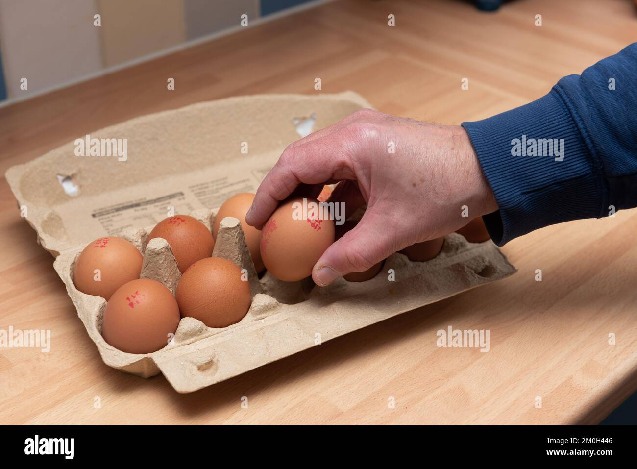 Lancashire United Kingdom. Taken on 6 December 2022. Man taking an egg