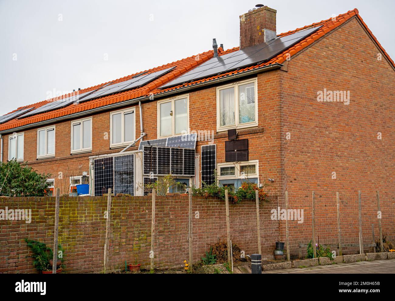 Houses with large collection of solar panels Stock Photo