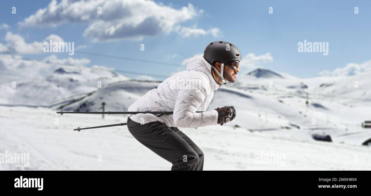Profile shot of a male skier skiing on a mountain Stock Photo