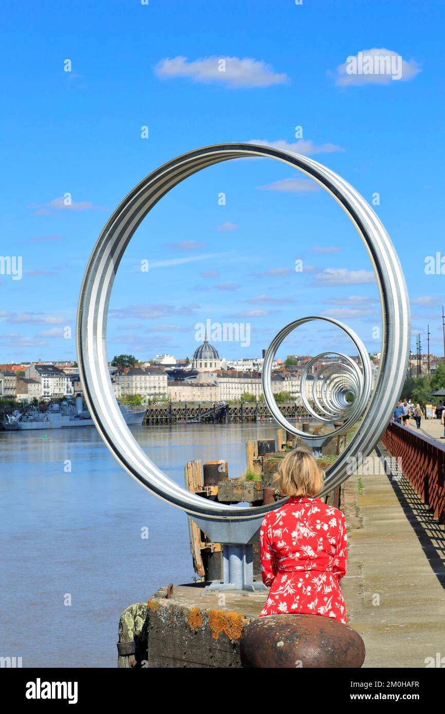 France, Loire Atlantique, Nantes, Nantes island, Quai des Antilles, Rings of Buren with the city center and the Notre Dame de Bon Port church in the background Stock Photo