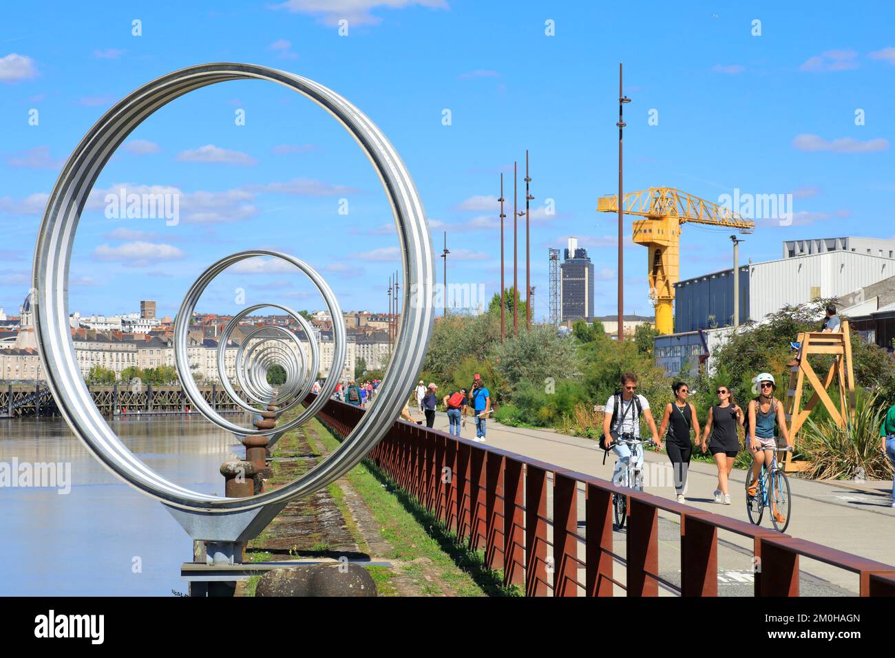 France, Loire Atlantique, Nantes, Nantes island, Quai des Antilles, Rings of Buren with the yellow Titant crane in the background and the city center Stock Photo