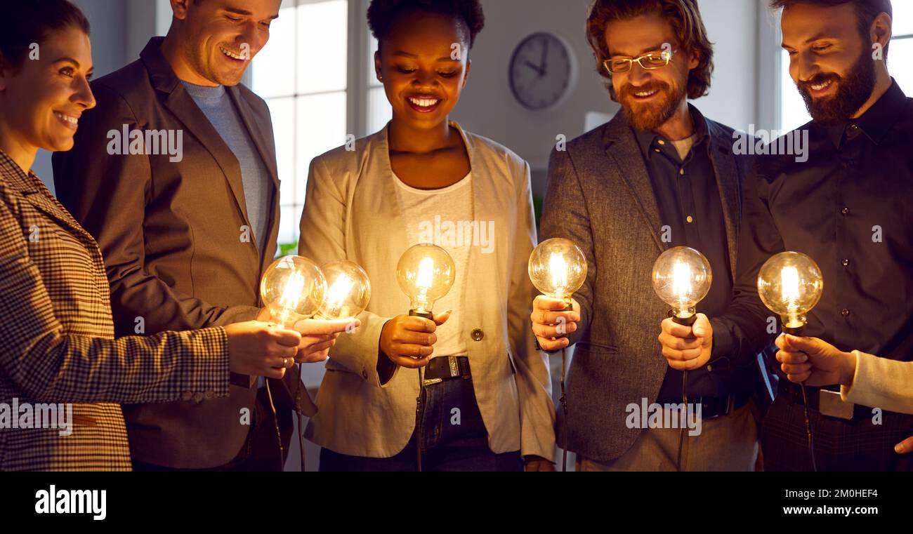 Team of business people with light bulbs work together and develop creative ideas Stock Photo