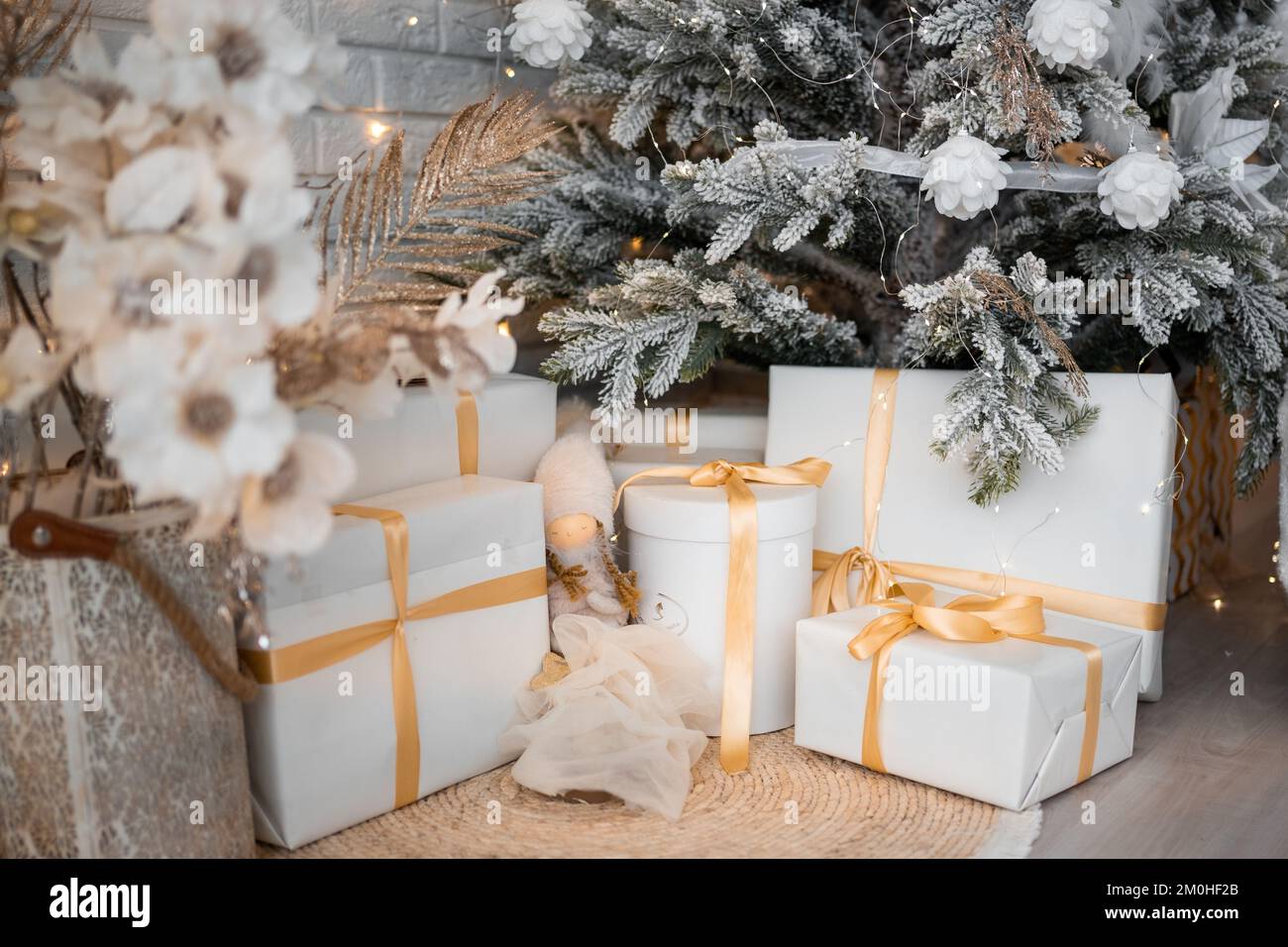 Beautiful Christmas gift boxes on floor near fir tree in room Stock ...