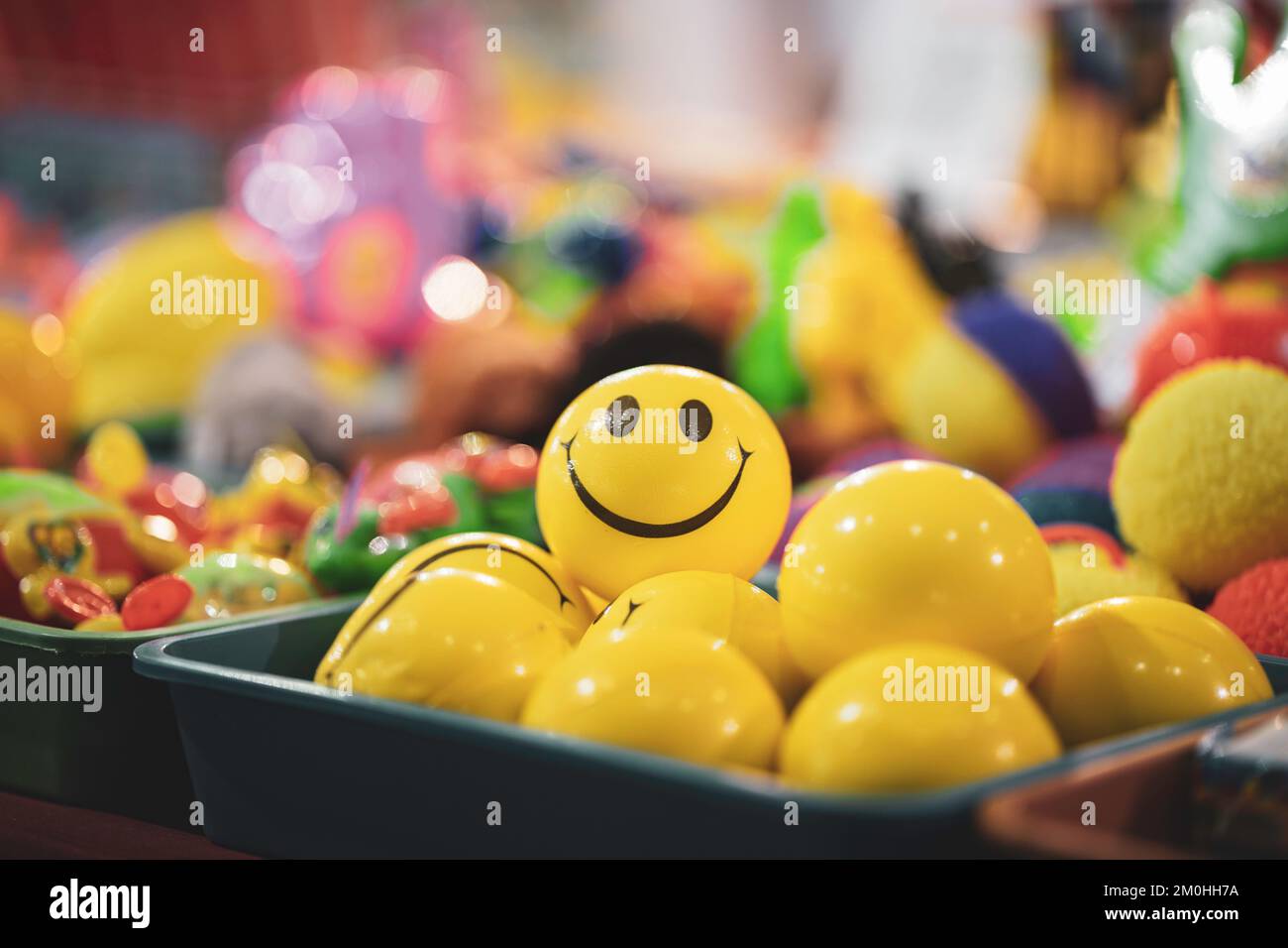 Yellow color smiley or happy ball or smiley or happy face ball stacked and selling in market of india fair of Stock Photo