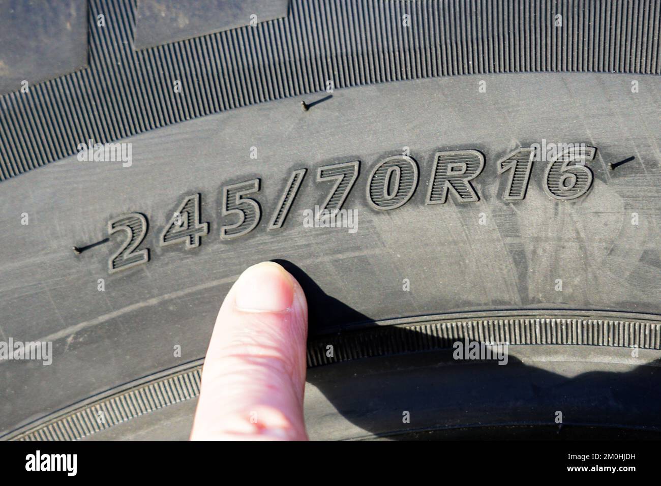 Side view of new tire with tire width, height and wheel diameter