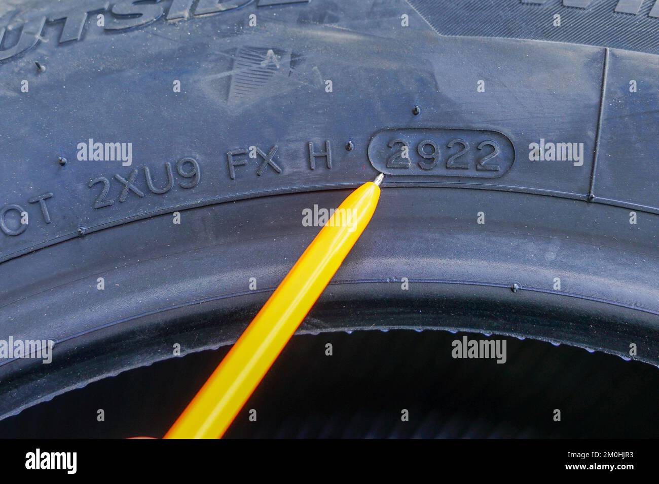 Side view of new tire with designation of week and year of tire