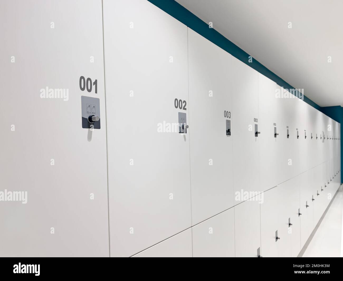 Gym Locker Room, Lockers , Dressing Room. Closed cabinets with white wooden doors starting from number 1 Stock Photo