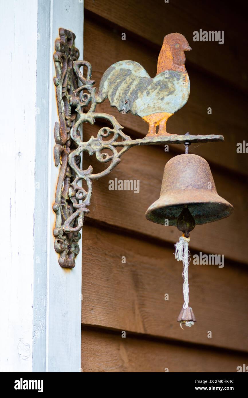 A vertical shot of a rustic doorbell with a cockerel Stock Photo - Alamy