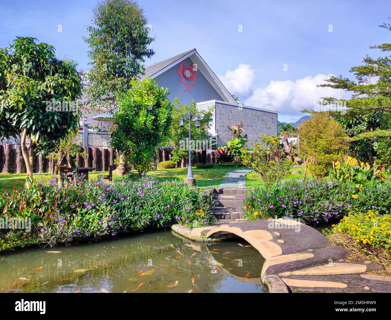 Garden of a Villa in Ciwidey with Pond filled with Koi Fishes in Ciwidey, West Java, Indonesia Stock Photo