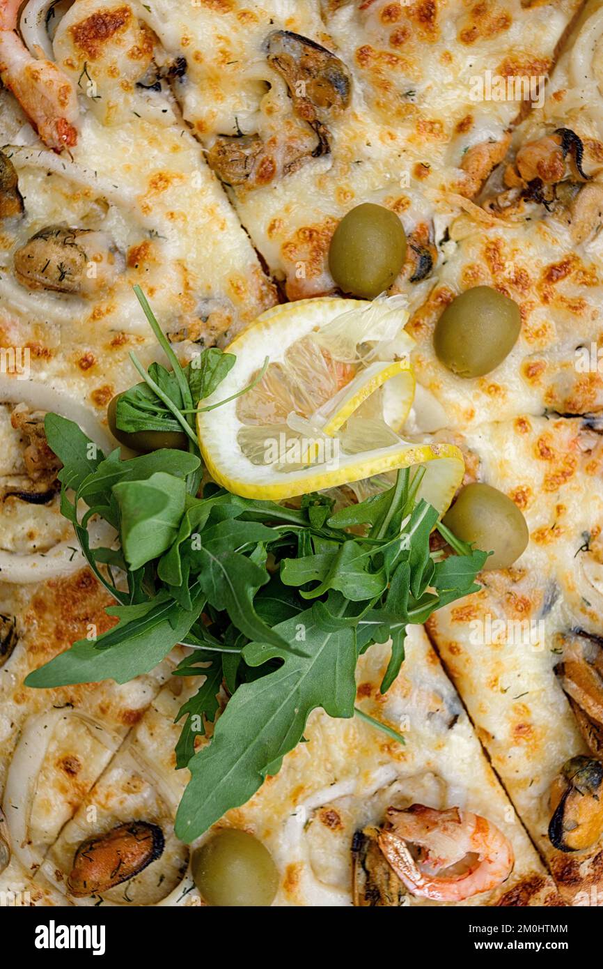Marinara Pizza With Squid Mussels Shrimp Olives And Lemon Top View marinara-pizza-with-squid-mussels-shrimp-olives-and-lemon-top-view