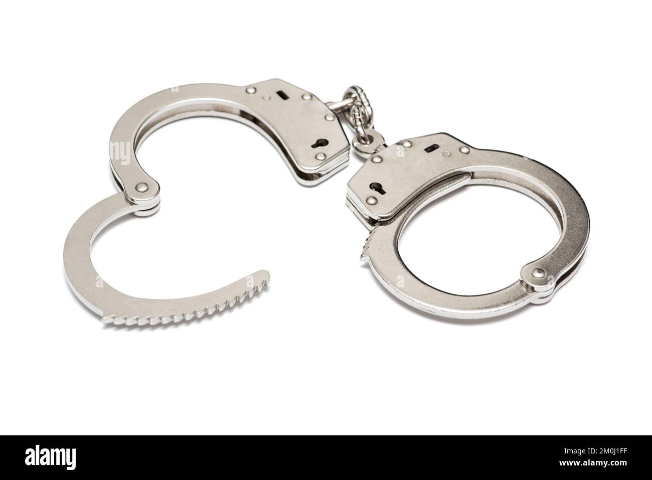 Pair of steel handcuffs isolated on white background. Silver metal