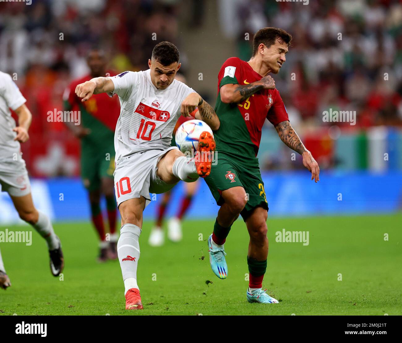 Doha, Qatar, 6th December 2022.  Granit Xhaka of Switzerland and Otavio of Portugal during the FIFA World Cup 2022 match at Lusail Stadium, Doha. Picture credit should read: David Klein / Sportimage Stock Photo