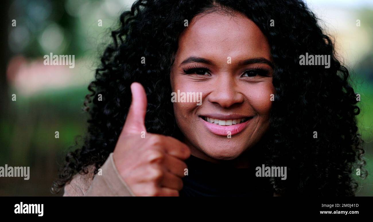 Positive Black woman giving approval with thumb up Stock Photo - Alamy