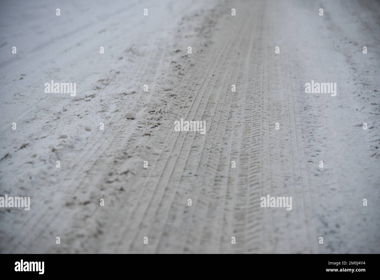 Wheel tracks on the winter road covered with snow. Stock Photo