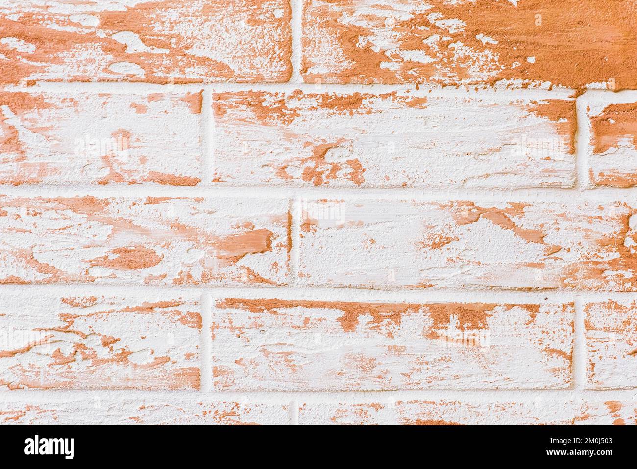 Light white brick wall with orange decorative paint patterns texture background. Stock Photo