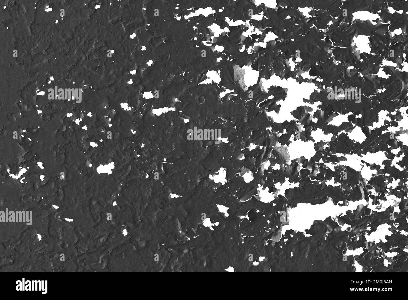 Black painted dark metal surface with old white peeling paint pattern