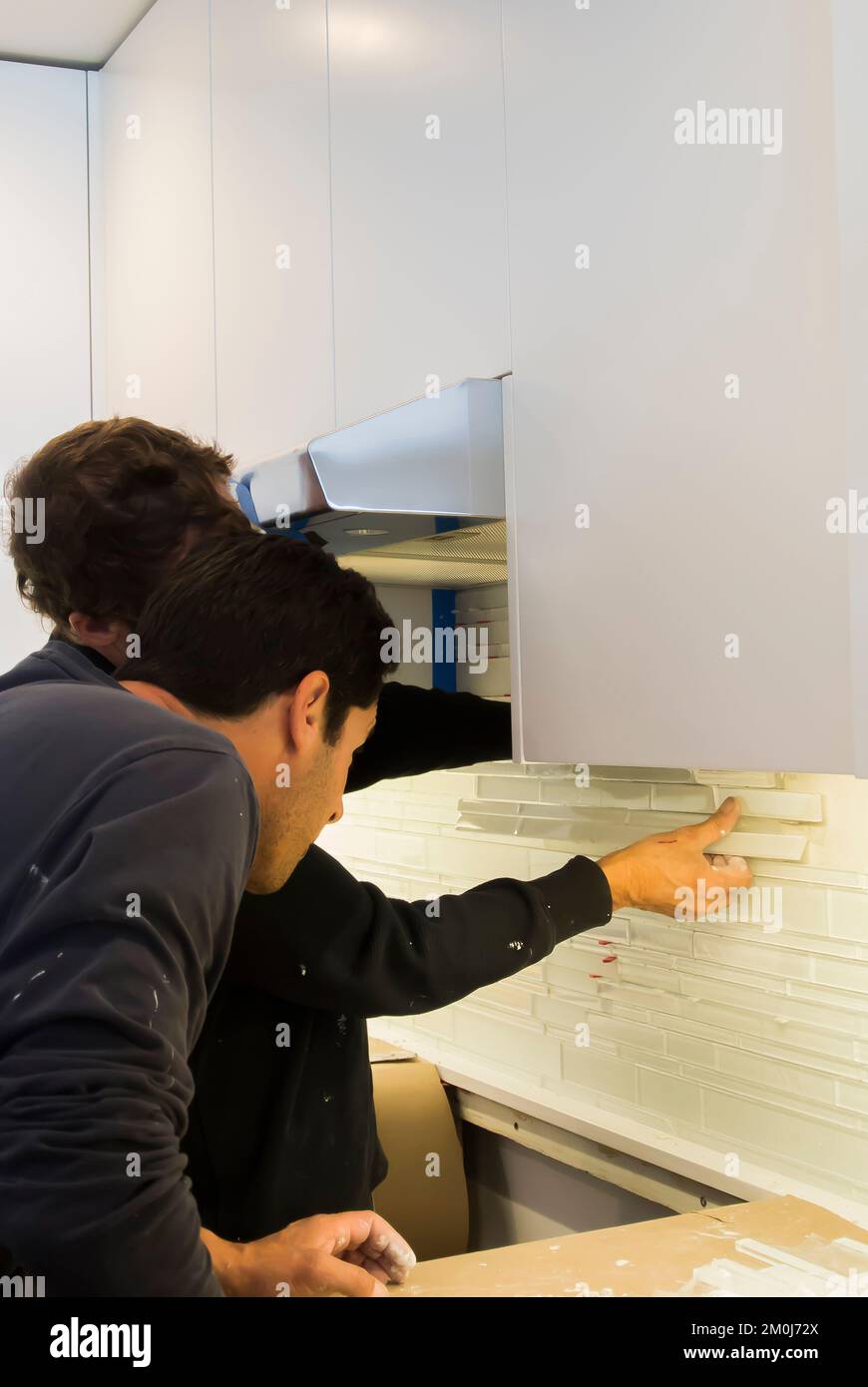 Construction Installation of Backsplash in Kitchen Remodel Stock