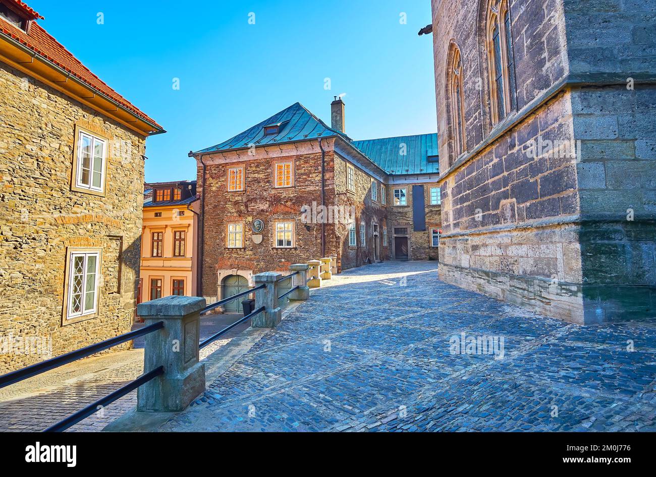 The stone courtyard of St Bartholomew Parish Church with a building of Dvorakovo Museum, Kolin, Czech Republic Stock Photo