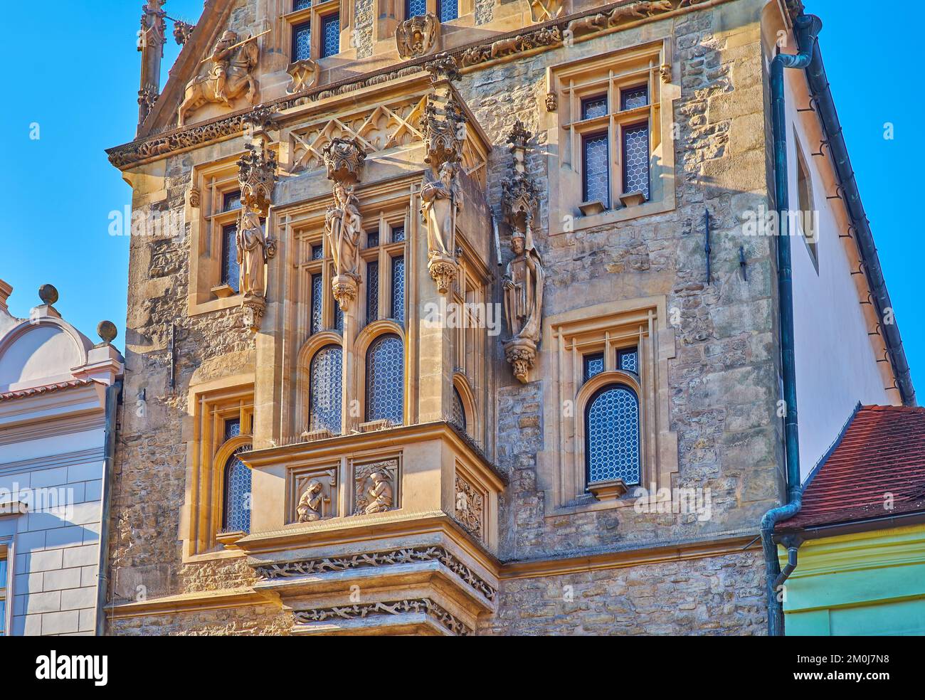 Ornate facade details of the Stone House with carvings, sculptures and oriel window, Kutna Hora, Czech Republic Stock Photo
