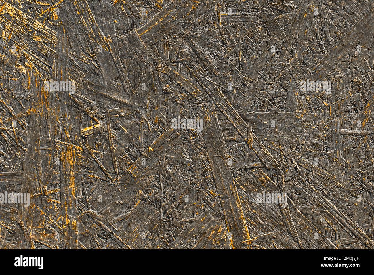 Dark paint on abstract surface of pressed wood chipboard texture