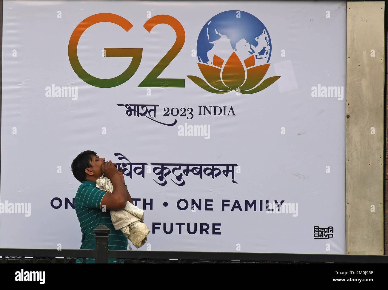 A man walks past a G20 logo printed on a banner in Mumbai. G20 summit or Group of Twenty summit presents opportunity to showcase India to the world. It will bring great opportunities for tourism and boost local economy. Prime Minister Narendra Modi has sought support of opposition leaders of all political party to make it a success. Stock Photo