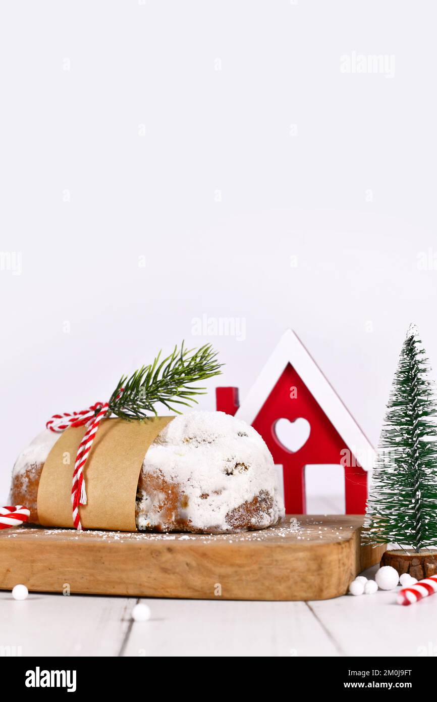 Traditional German Stollen cake, a fruit bread with nuts, spices, and dried fruits with powdered sugar, served during Christmas time Stock Photo