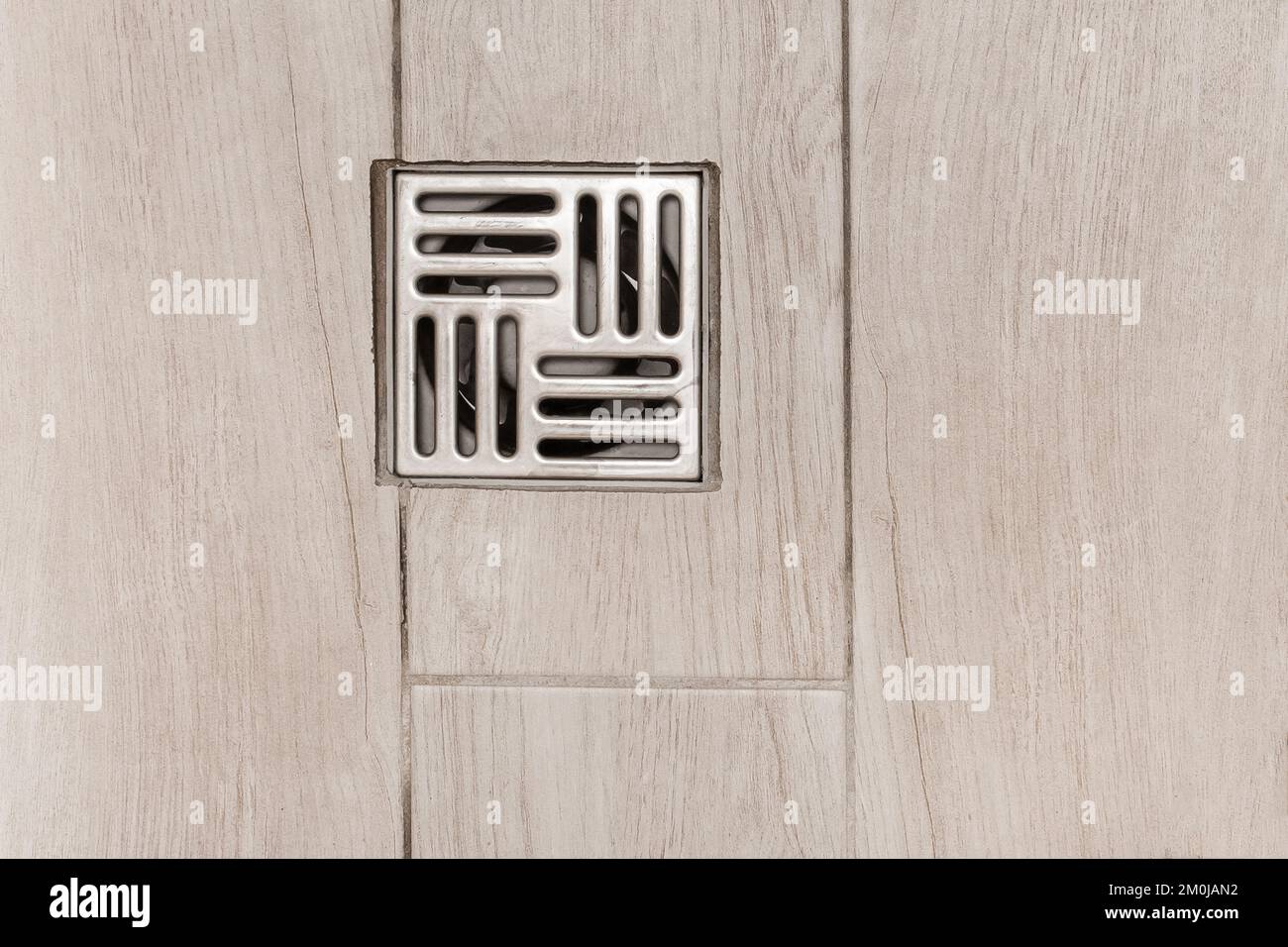 Metal hole for flushing water in a bathroom shower floor drain tile