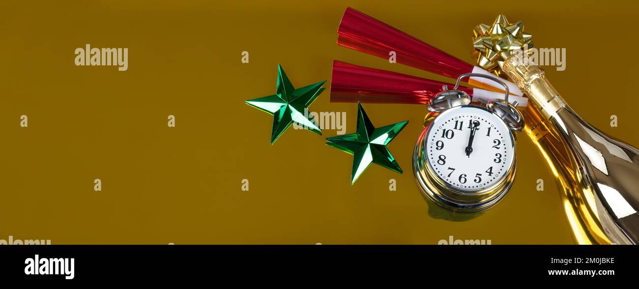 Clock strikes midnight for New Year celebration on a gold background