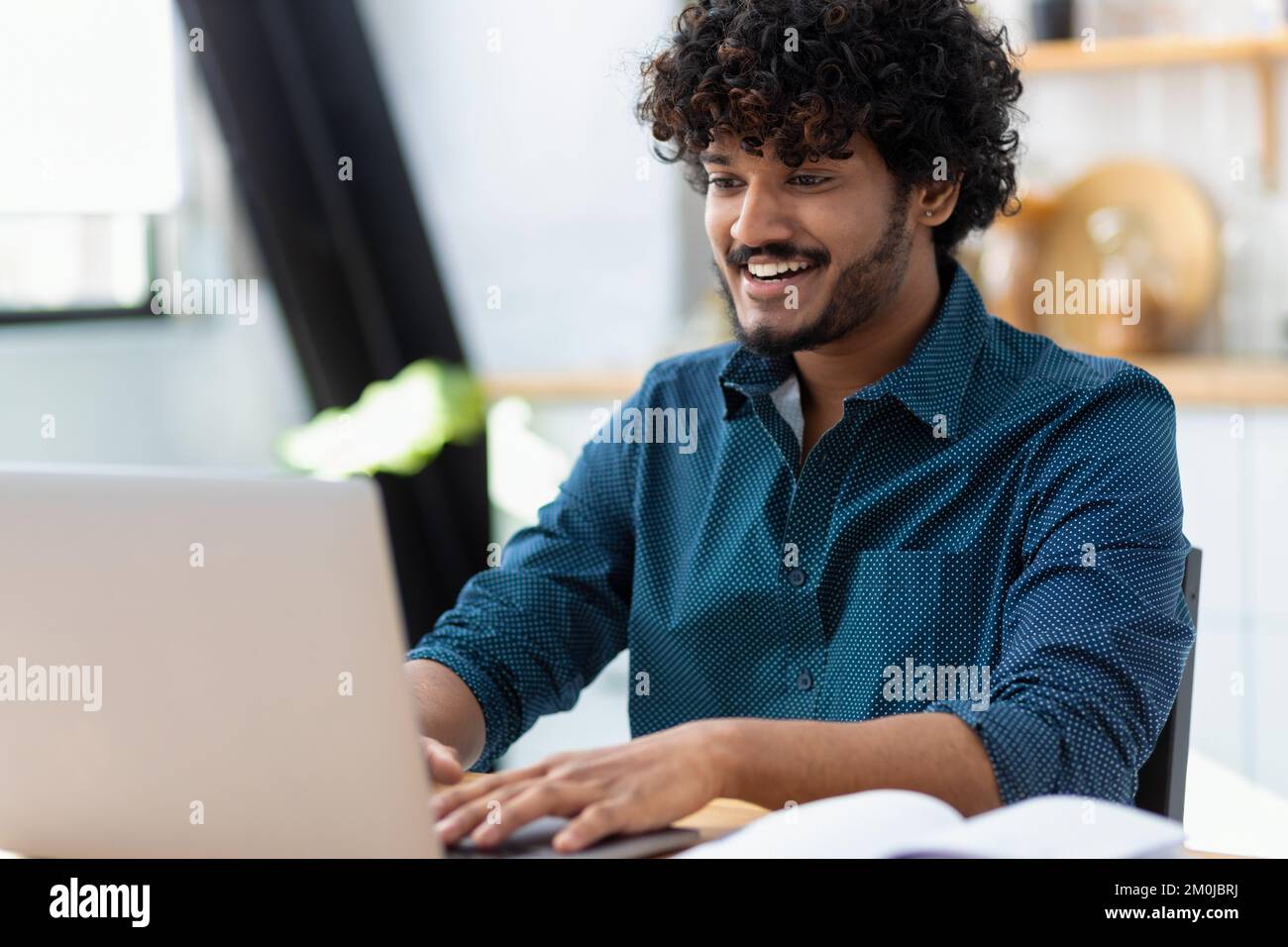 man freelancer using laptop computer typing working online coworking or modern office Distance learning online education Stock Photo