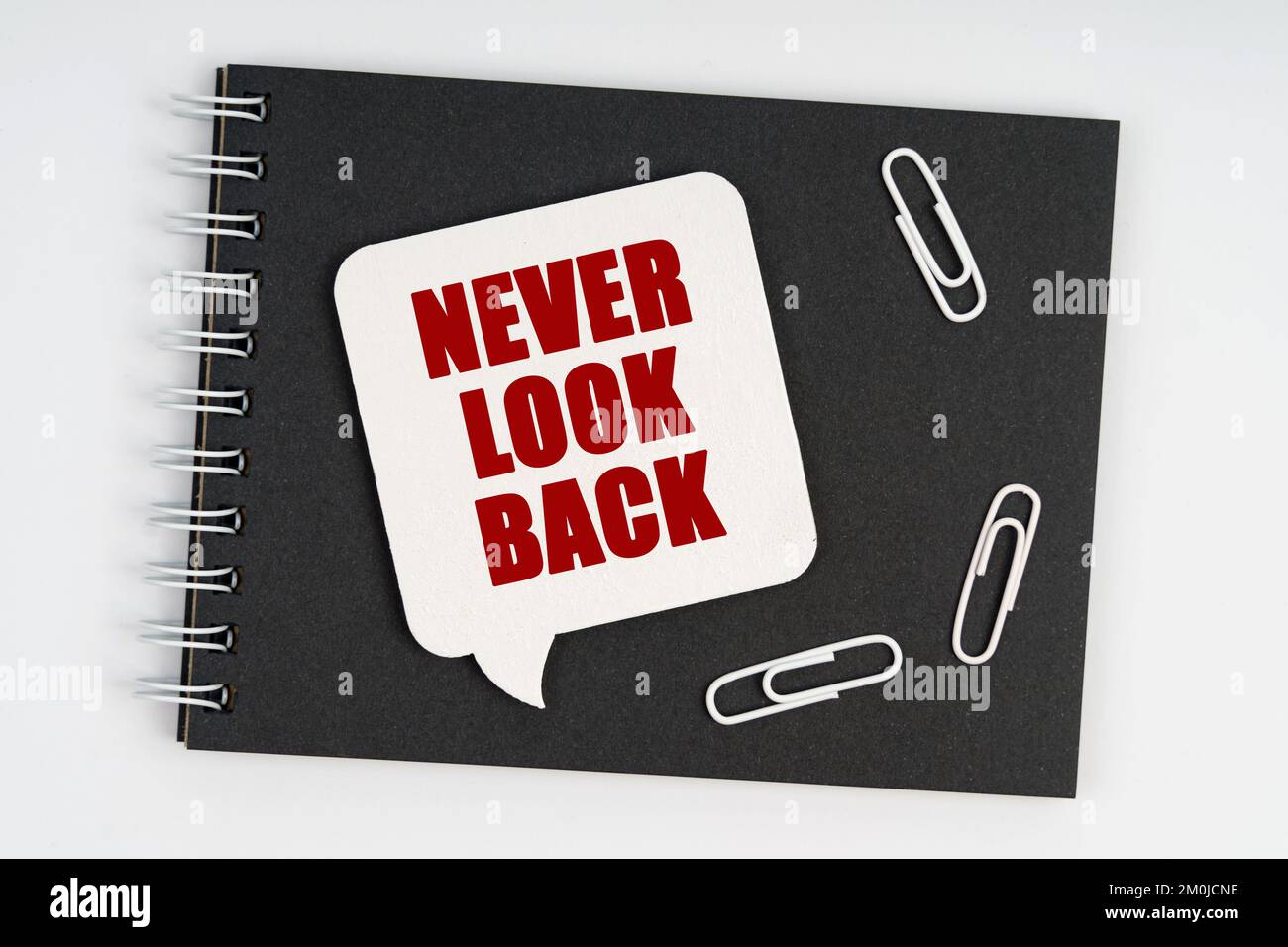 Business concept. On the notebook are white paper clips and a sign with