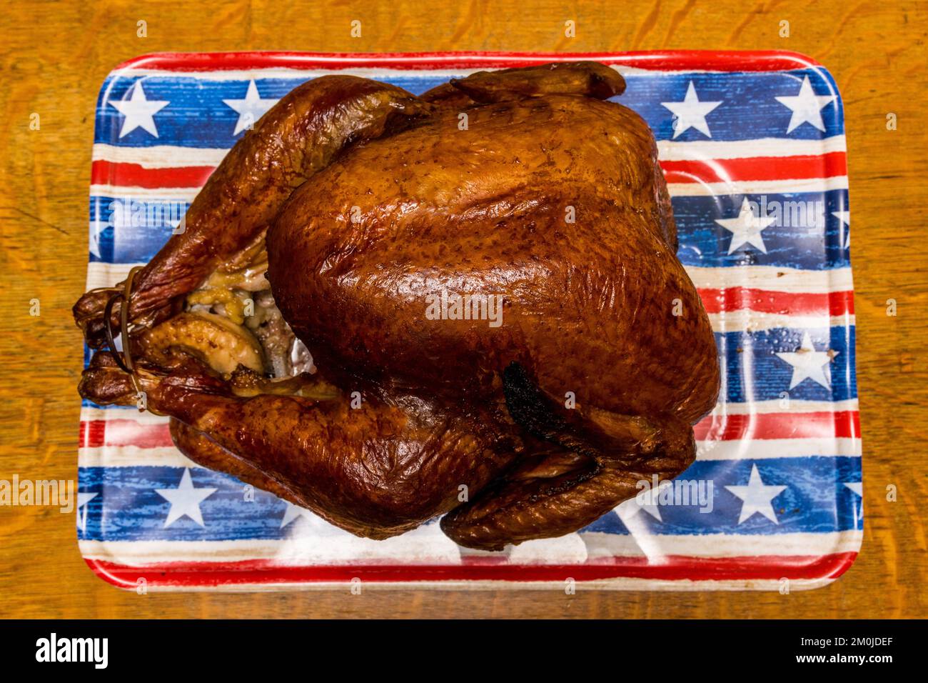 A Foster Farms Thanksgiving turkey smoked with apple wood on a Weber kettle barbecue Stock Photo