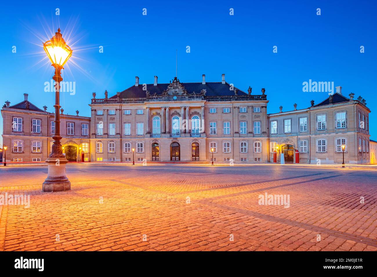 Amalienborg Palace in Copenhagen, Denmark at twilight.  Amalienborg Palace is the home of the Danish royal family. Stock Photo