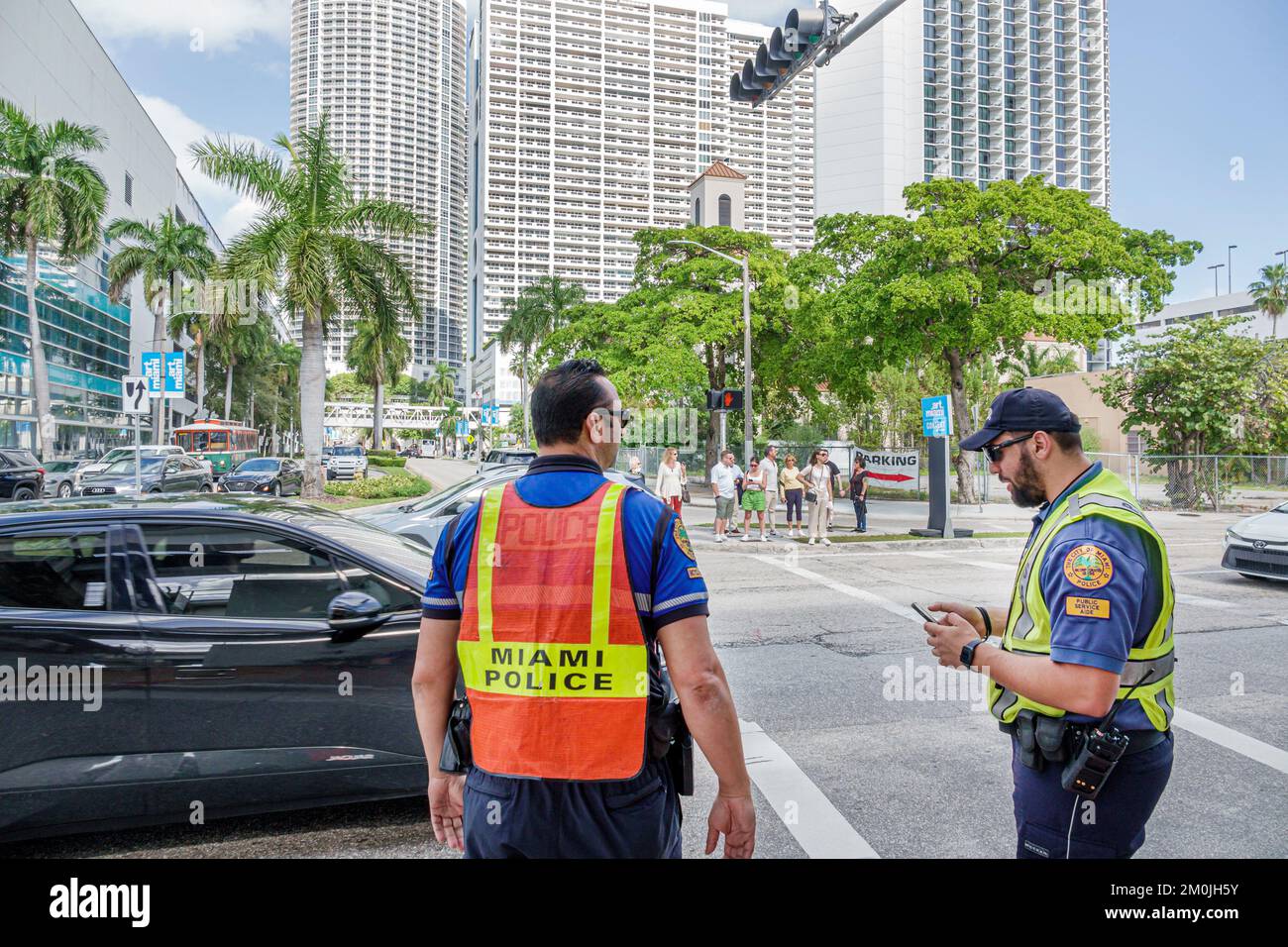 Miami Florida,Biscayne Boulevard,city police policeman policemen directing traffic,man men male adult adults,employee employees worker workers working Stock Photo