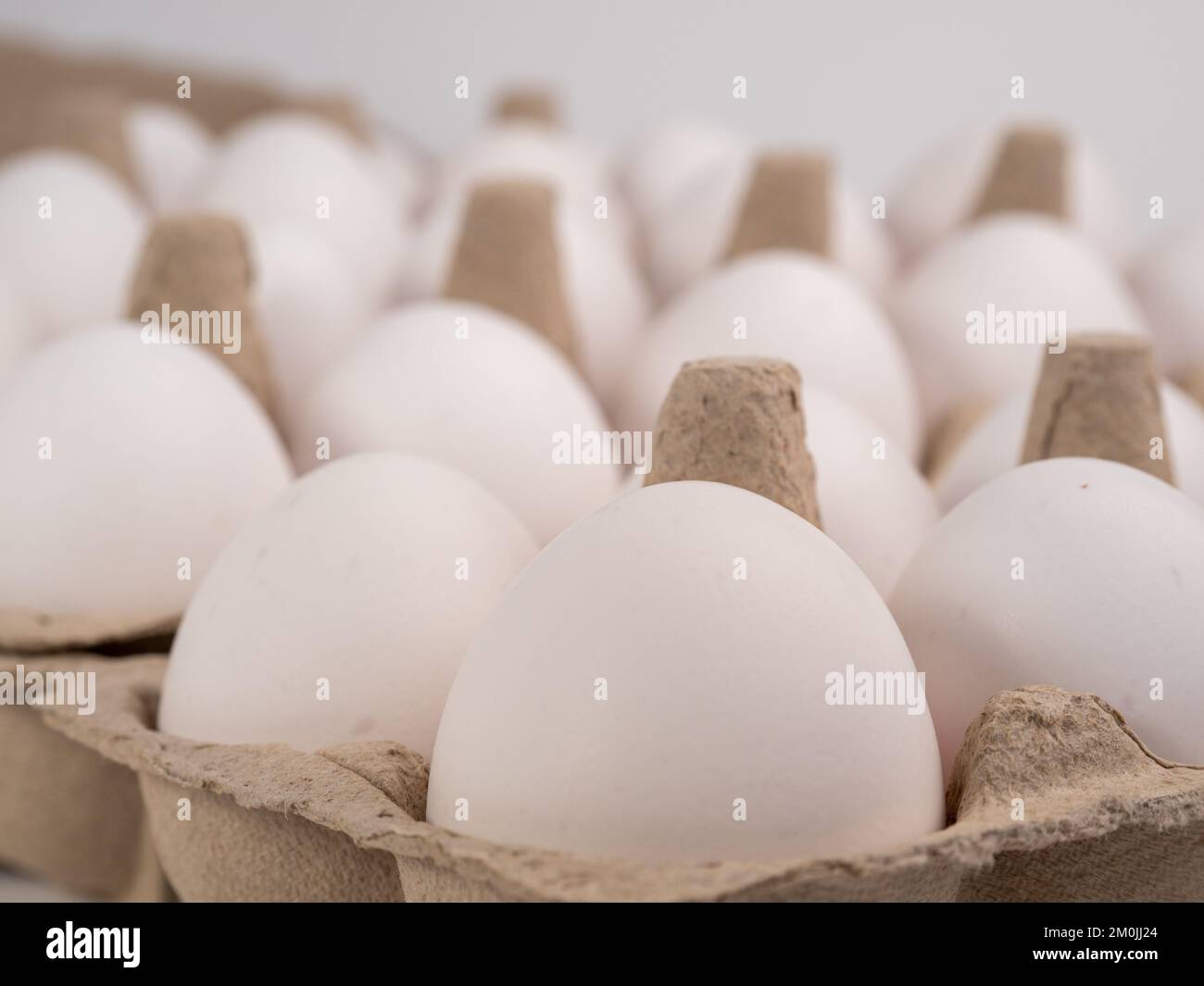 Chicken eggs in a package. White eggs in a box. Closeup Stock Photo