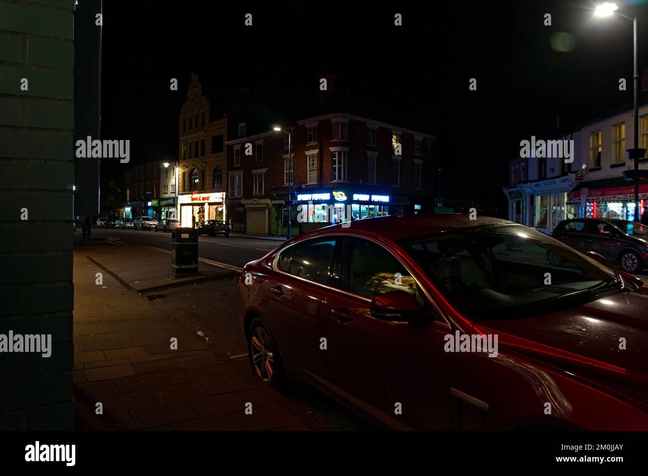 West Street at night with modern Jaguar car parked in the foreground Stock Photo