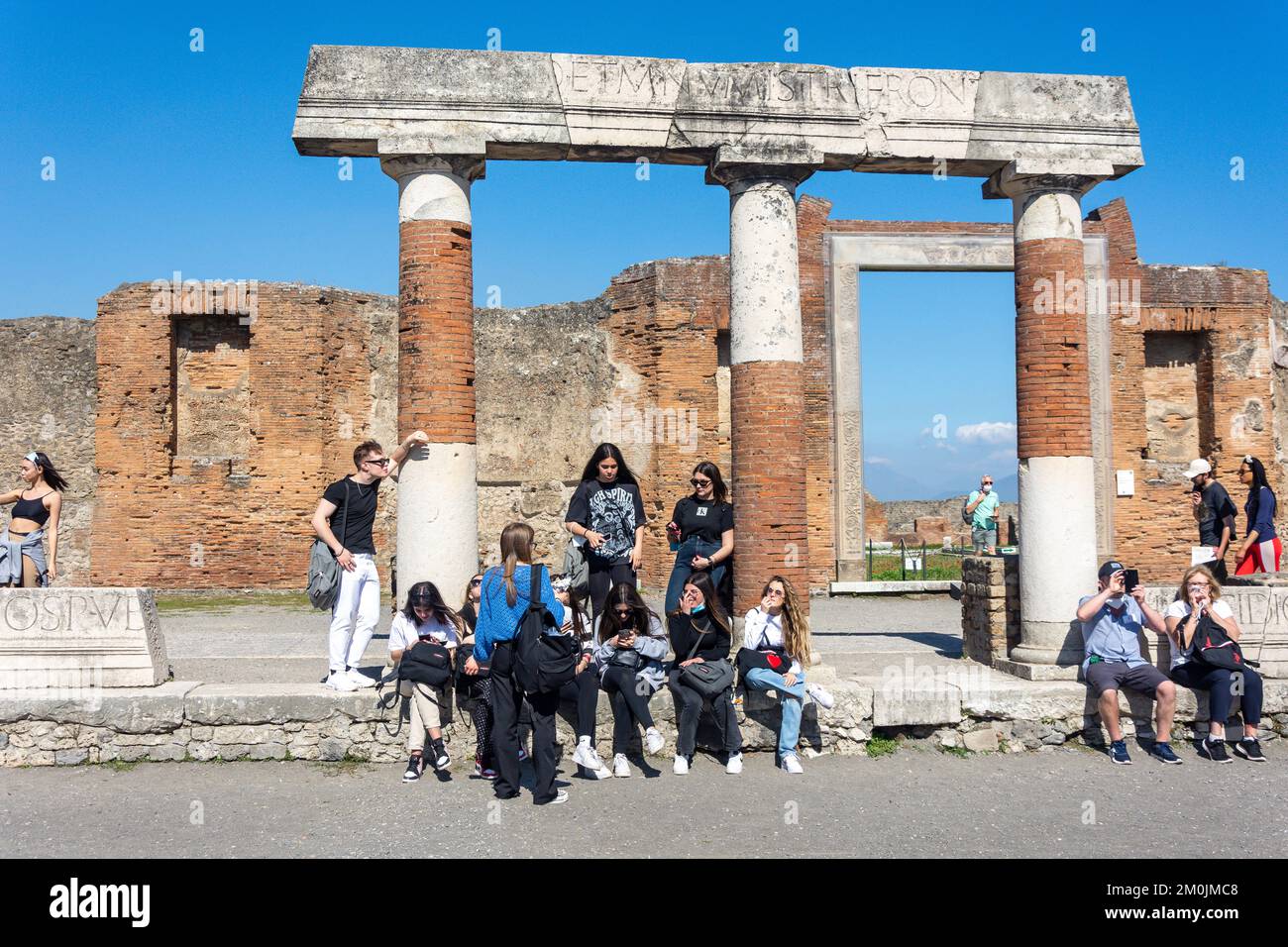 Young women tourist group at The Forum, Ancient City of Pompeii, Pompei, Metropolitan City of Naples, Campania Region, Italy Stock Photo