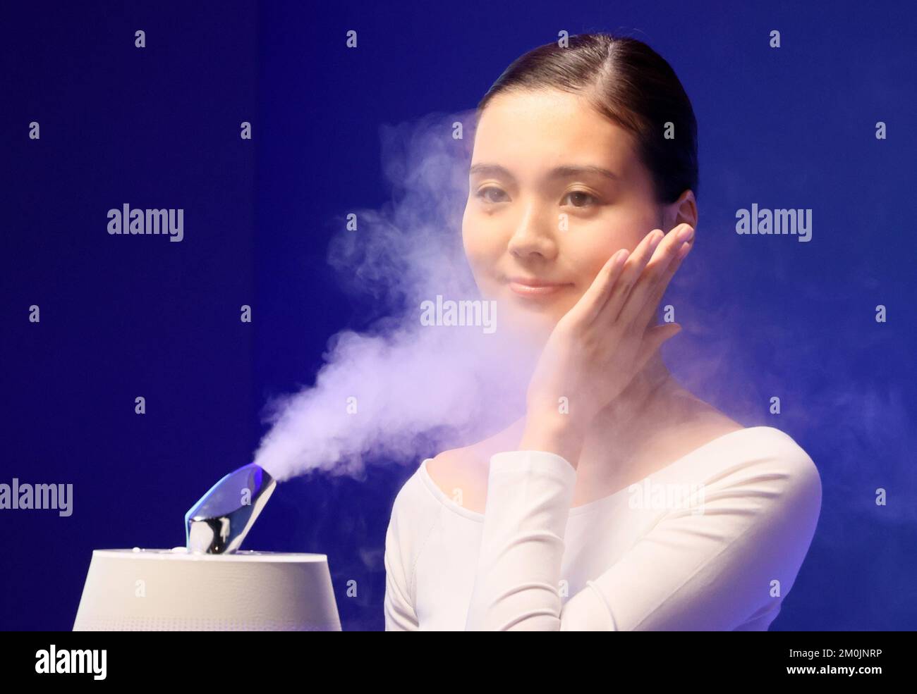 Tokyo, Japan. 6th Dec, 2022. A model displays Japanese high tech venture Kaltech's beauty humidifier with photocatalytic technology "Yurugi Jyunsui Premier" which purifies sprayed water with photocatalytic technology and decomposes bacteria in the tray in Tokyo on Tuesday, December 6, 2022. The new humidifier can transform humidifier to beauty machine with a beauty attachment. Credit: Yoshio Tsunoda/AFLO/Alamy Live News Stock Photo