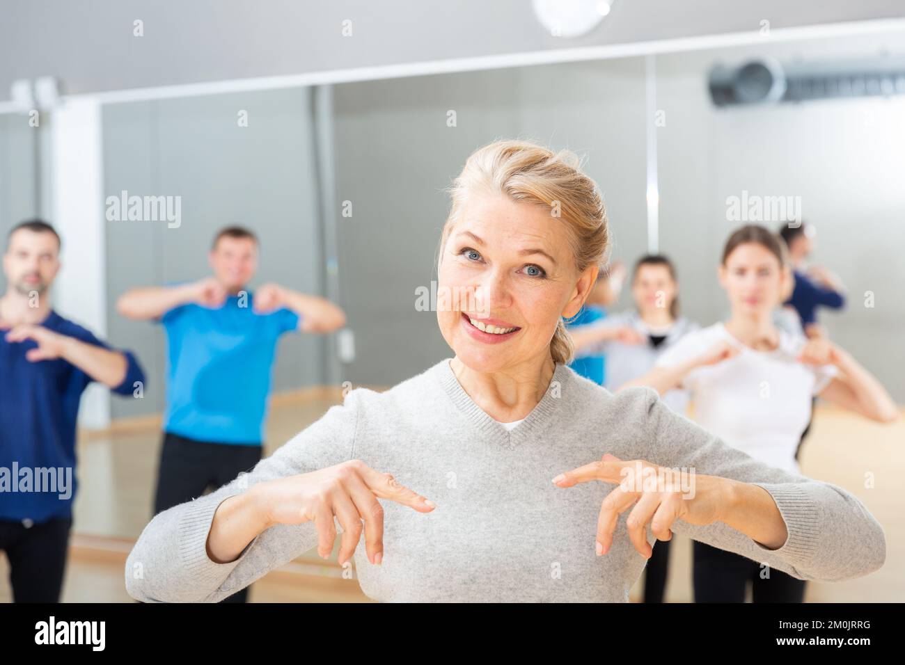 Mature woman practicing vigorous dance Stock Photo