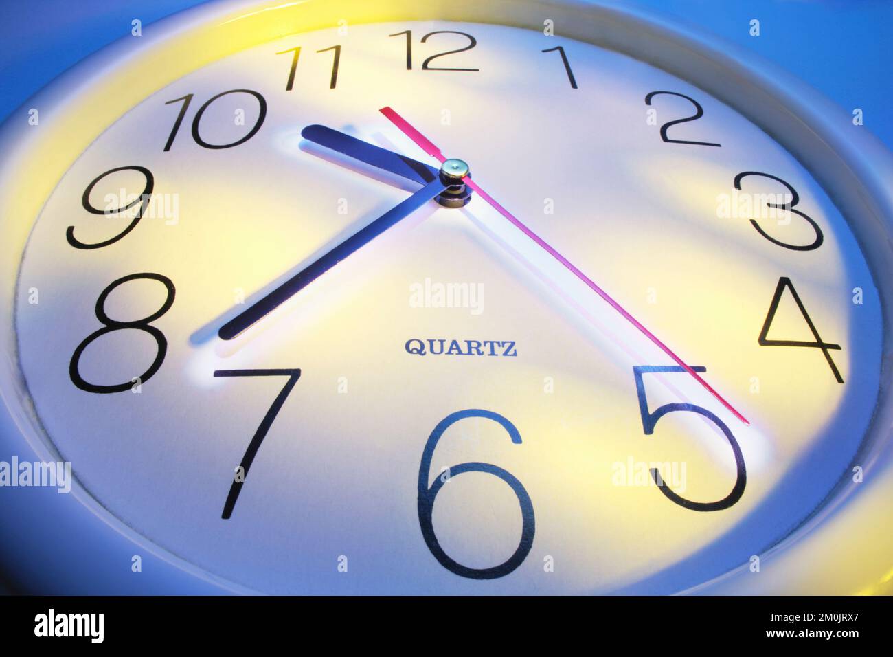 Close Up of Clock on Blue Background Stock Photo